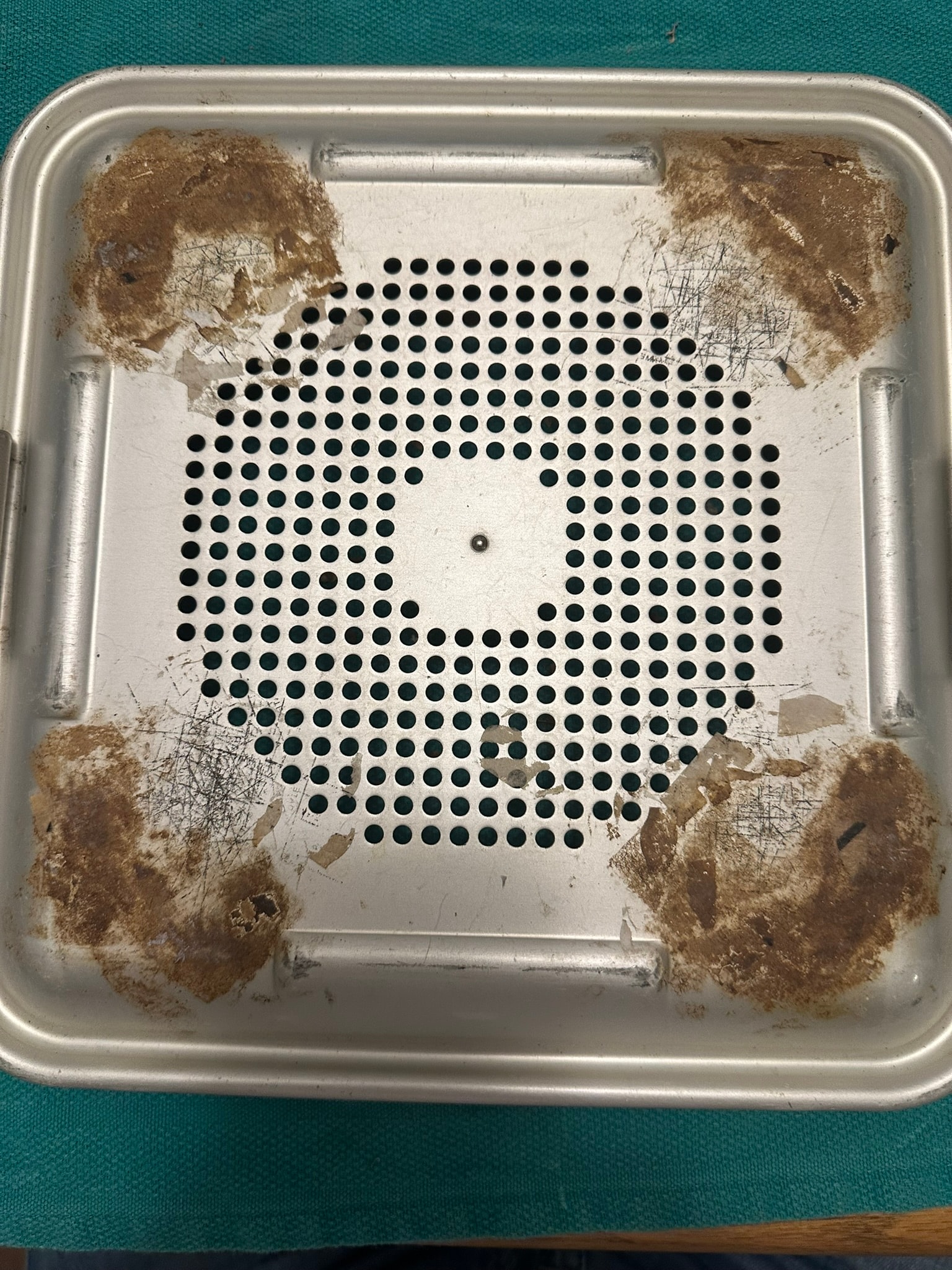 Sterile container before cleaning — debris and residue visible